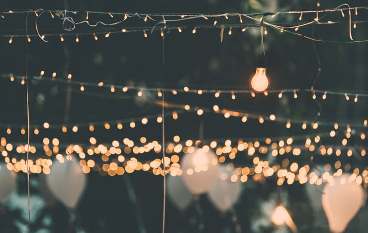 Lights hanging over an outdoor event.