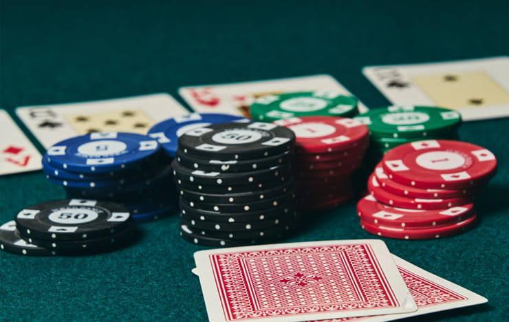A poker table with chips and playing cards.