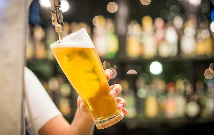 Cold beer being poured into a glass.