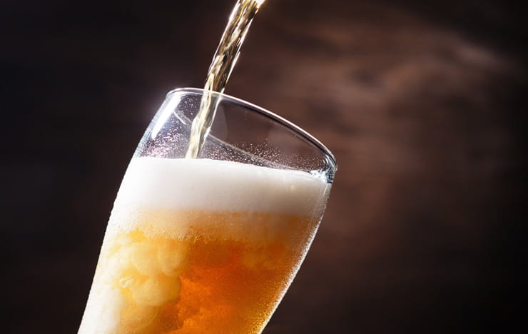 A beer being poured into a glass.