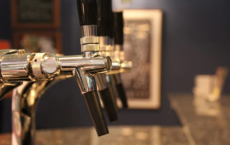 Beer taps at a bar.