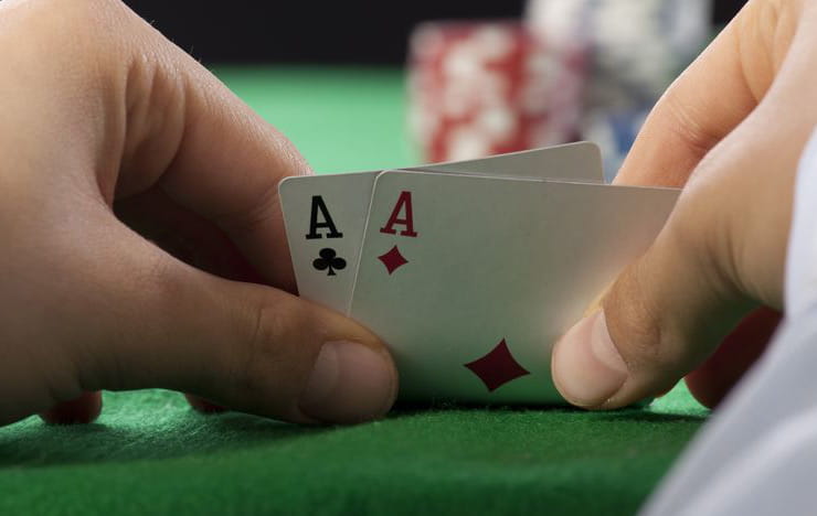 A poker hand showing pocket aces.