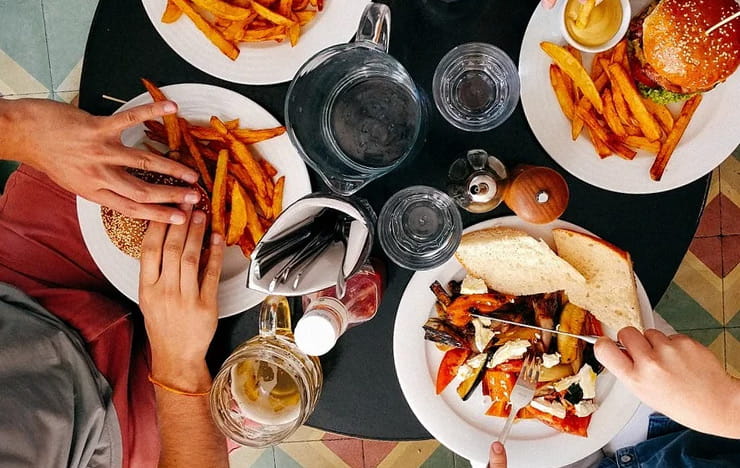 A couple eating food at a restaurant.