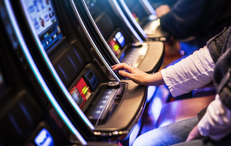 People playing slot machines.