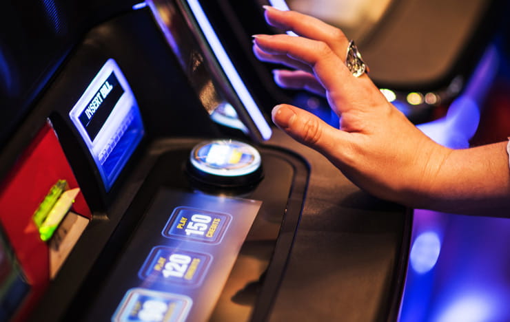 A player spinning the reals of a slot game.