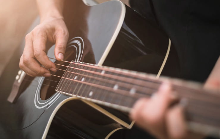 A guy playing a guitar.