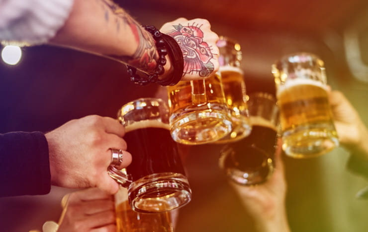 A group of friends clinking beer glasses together.